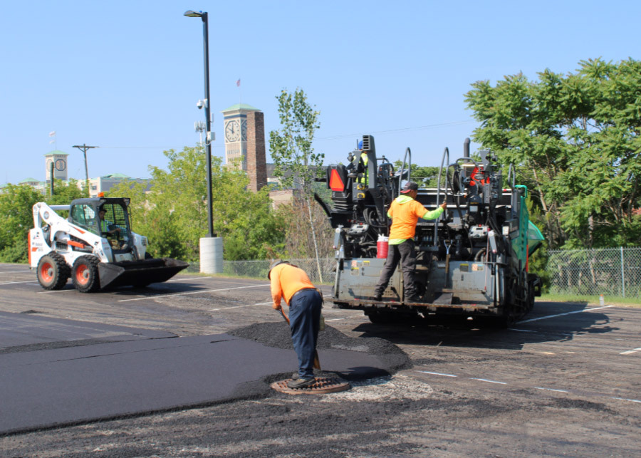 Johnson and Sons Paving workers Completing Asphalt Project