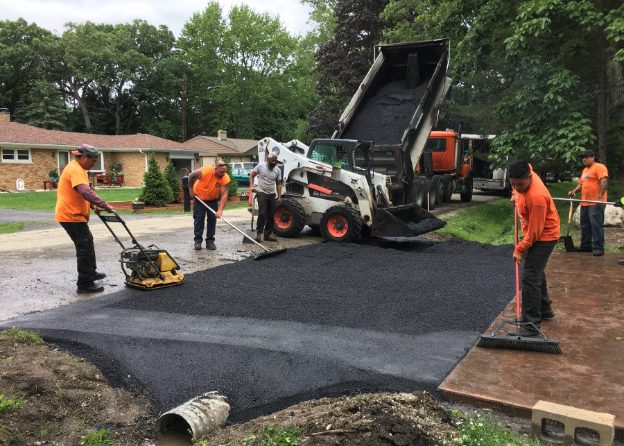 Johnson & Sons Workers Completing Asphalt work on a Residential Driveway