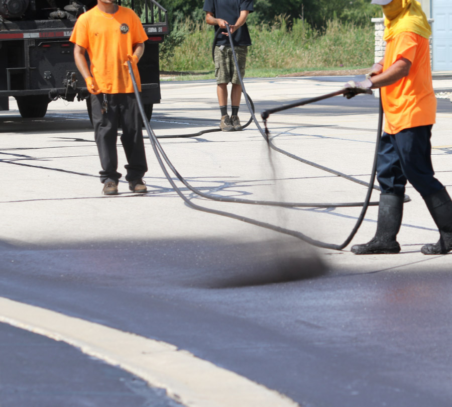 Johnson and Sons Paving Team Seal Coating Parking Lot
