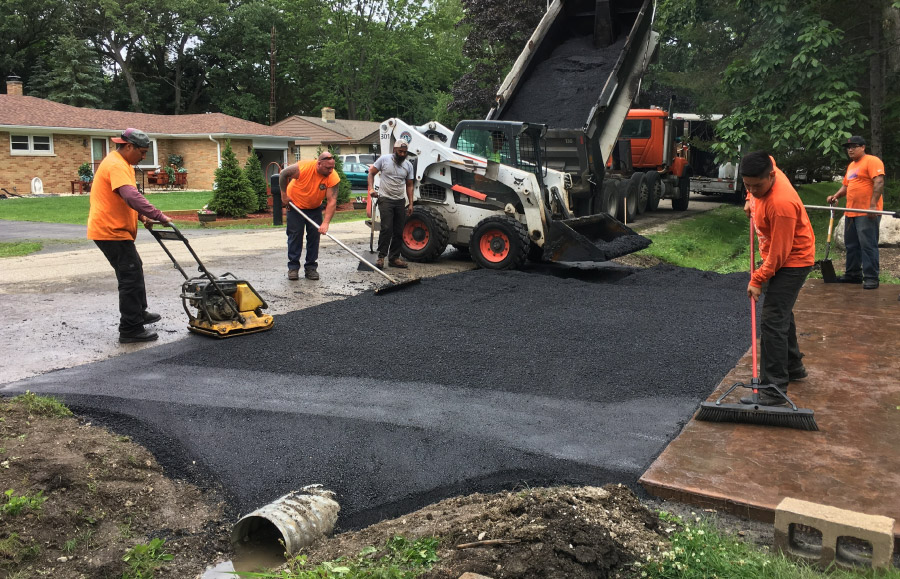 Johnson And Sons Paving Workers Completing a Residential Driveway