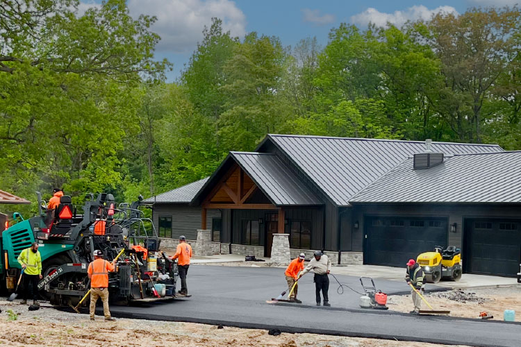 Johnson & Sons Workers Completing Asphalt work on a Residential Driveway